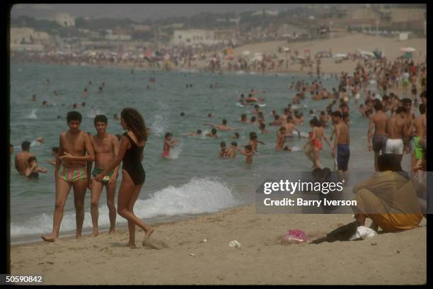 Bathing-suit brazen men & women crowding Club des Pins beach, no longer intimidated by Moslem fundamentalist pressure which emptied beaches for yr.