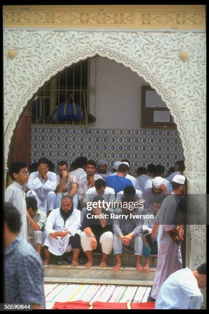 Fundamentalist Islamic Salvation Front members sitting outside, gathering at Kouba mosque for Fri. Prayers.