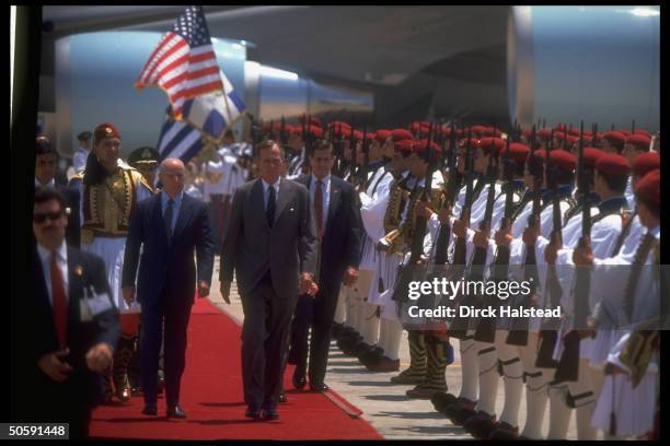 Presidents Bush & Karamanlis treading red carpet, reviewing Greek Repub. Guard , at Hellnikon Airport arrival fete.