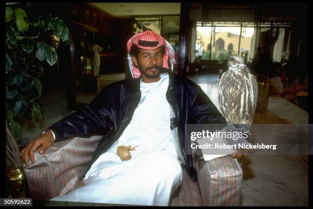 United Arab Emirate citizen w. His peregrine falcon, partners in hunting endangered bustard bird, at Sheraton Hotel in Karachi, Pakistan.