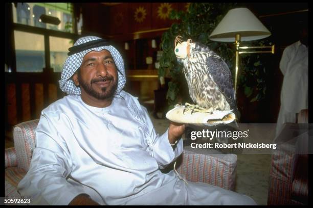 United Arab Emirate citizen w. His peregrine falcon, partners in hunting endangered bustard bird, at Sheraton Hotel in Karachi, Pakistan.