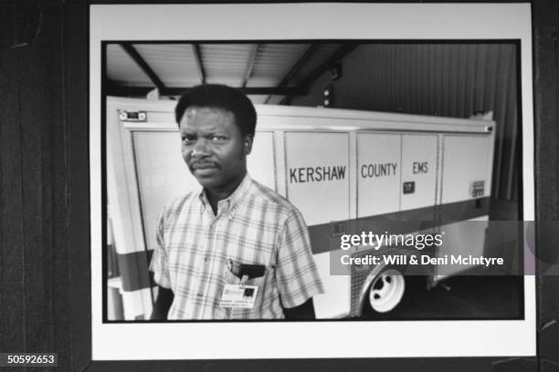 Robert Johnson, dir. Of Kershaw County's Emergency Medical Service, posing beside ambulance as he recalls the horrors of working the rescue operation...