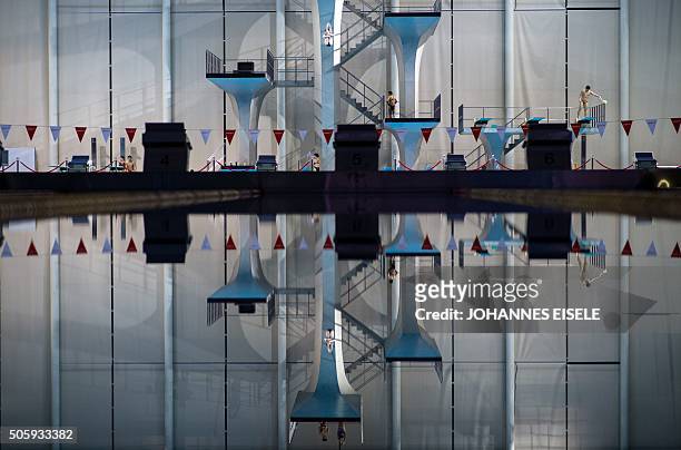 This photo taken on January 20, 2016 in Shanghai shows a member of the Chinese national Diving team jumping of the 10m platform during a training...