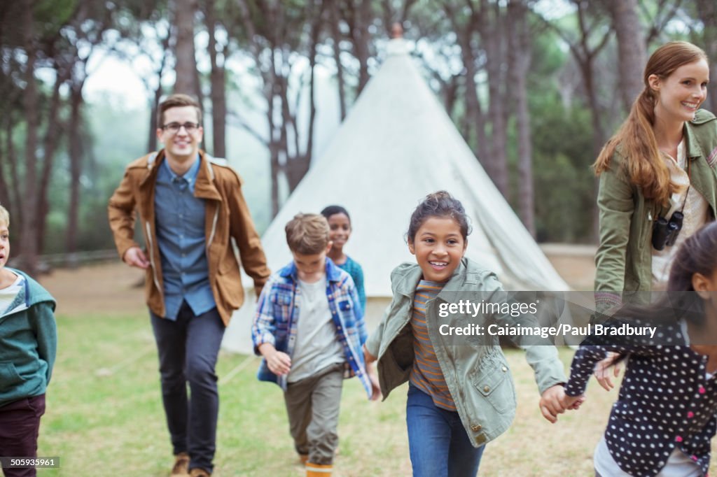 Teachers and students walking in forest