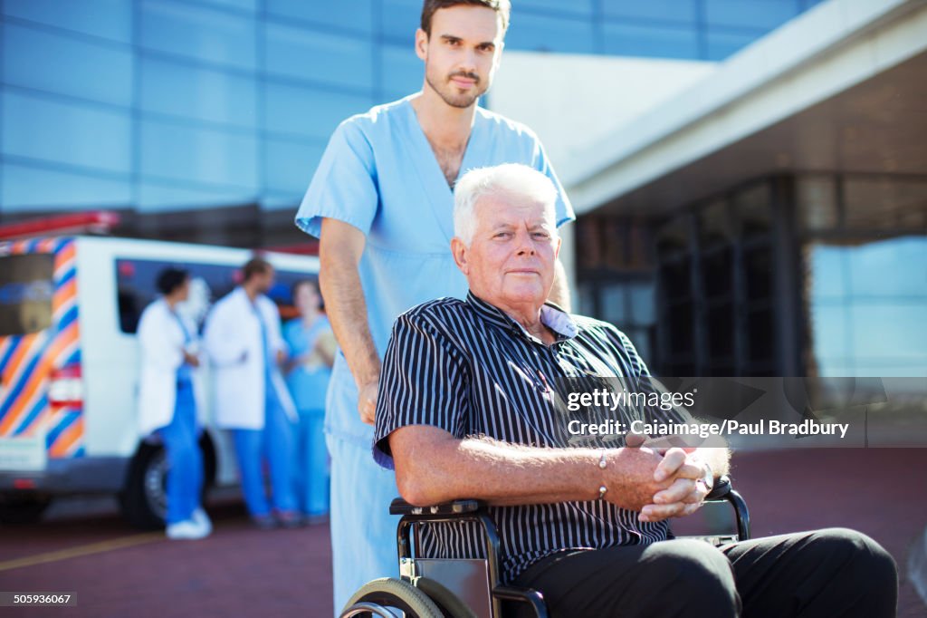 Nurse wheeling patient outside hospital