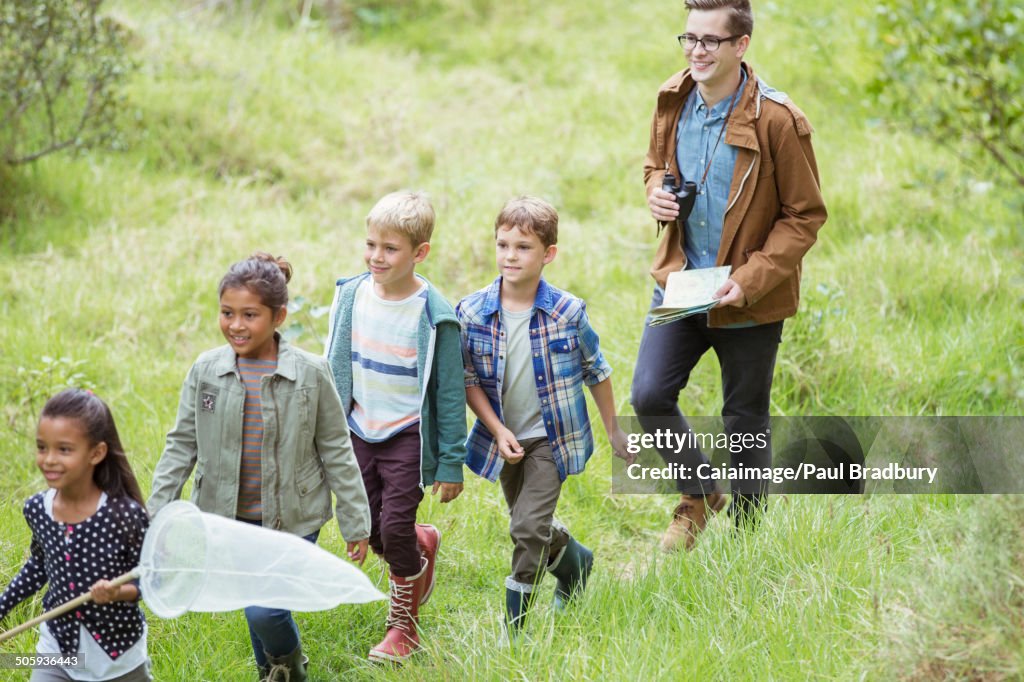 Students and teacher walking in field