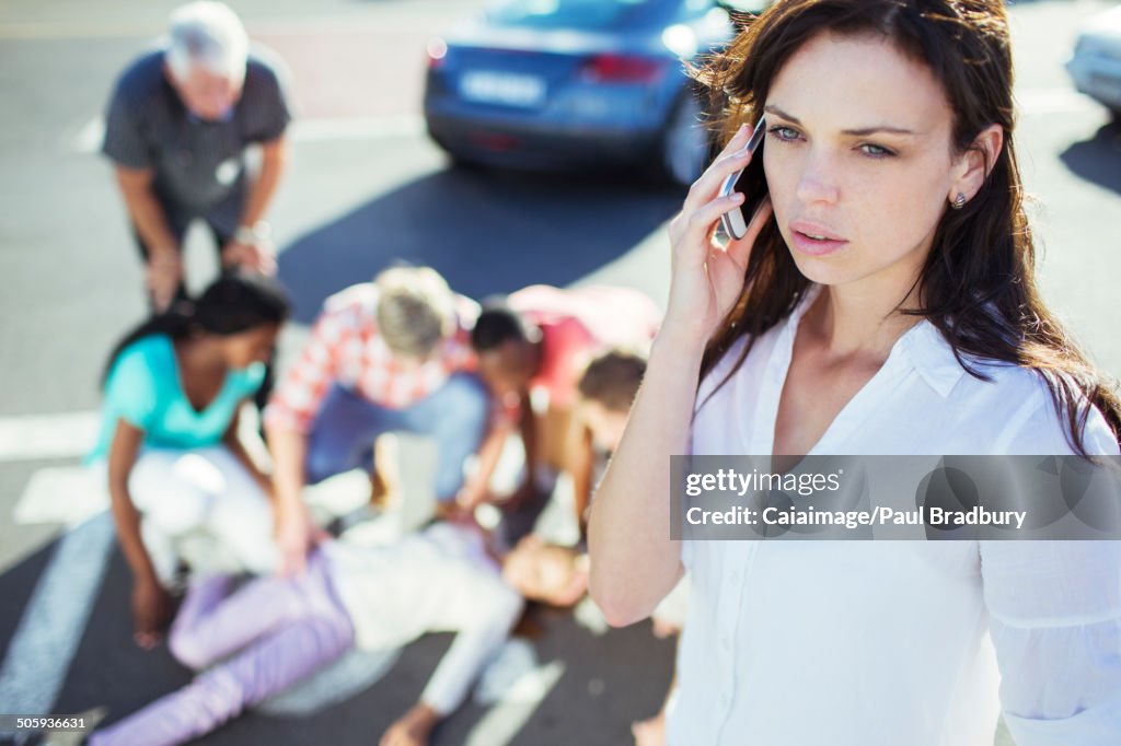 Woman calling emergency services at car accident