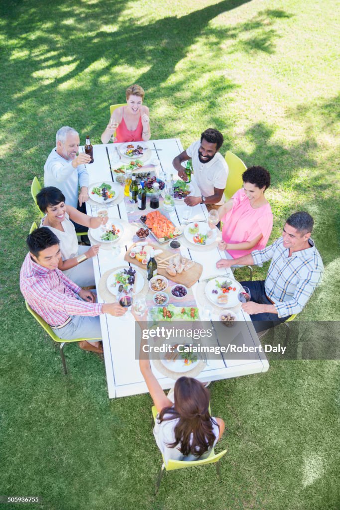 Friends eating together at table outdoors