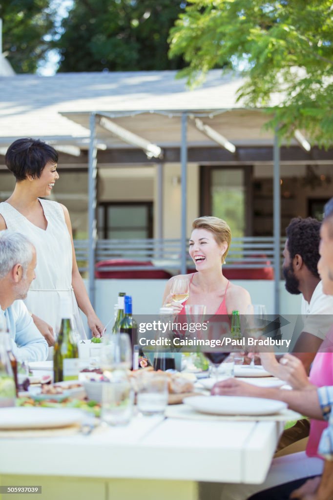 Friends eating together at table outdoors