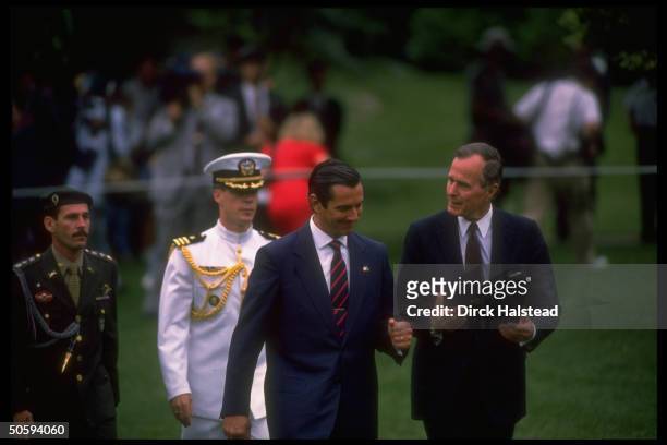 Pres. Bush & Brazilian Pres. Fernando Collor de Mello chatting amiably, strolling WH lawn w. Pair of ceremonial soldiers in tow.