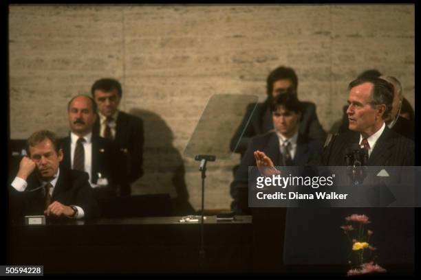 Pres. Bush addressing Federal Assembly, framed by legislators & Pres. Havel .