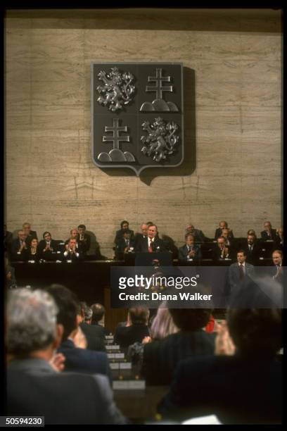 Pres. Bush addressing Federal Assembly, facing & framed by applauding legislators, w. Pres. Havel .