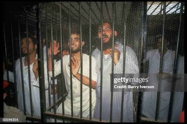 Caged defendants, Islamic fundamentalist extremists on trial for attacking Christians, shooting police & bombing tour busses, in court.