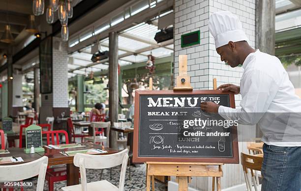 chef writing the menu at a restaurant - menu board stock pictures, royalty-free photos & images