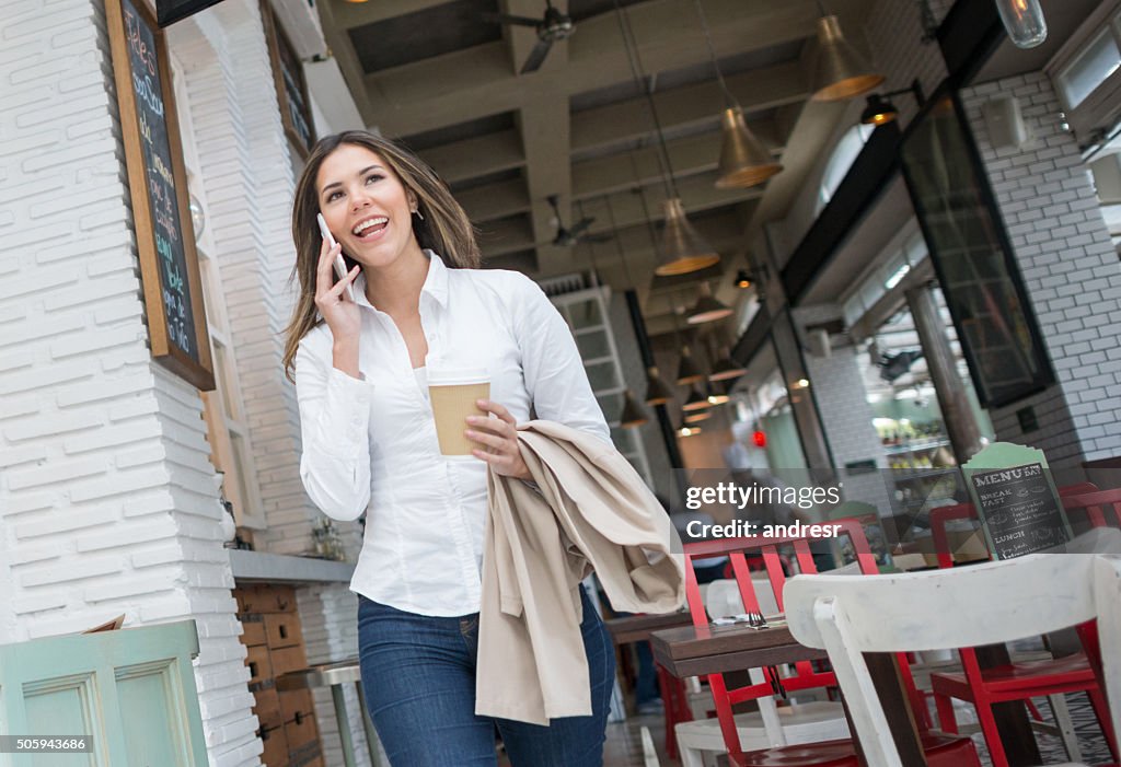 Woman having coffee to go at a coffee shop