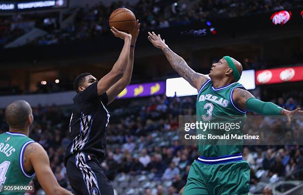Karl-Anthony Towns of the Minnesota Timberwolves takes a shot against Charlie Villanueva of the Dallas Mavericks in the first half at American...