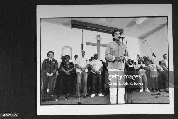 Musicologist & drummer for the Grateful Dead, Mickey Hart, standing at mike, introducing the members of the San Quentin Mass Choir in chapel at the...