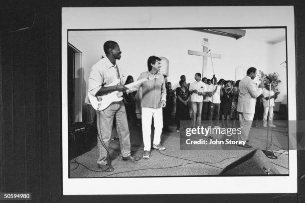 Mickey Hart , drummer for the Grateful Dead, looking on as prison chaplain Earl Smith performs w. Members of the San Quentin Mass Choir in chapel at...
