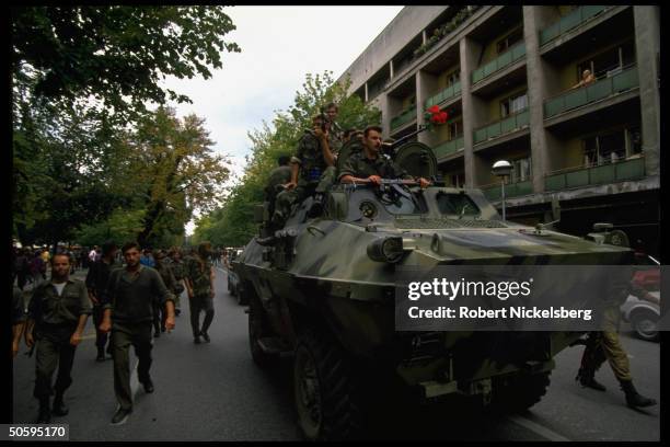 Bosnian Serb troops marching w. APC, protesting conditions on battle & home fronts, in mutiny by 1000 veteran civil war 1st Krajina Corp. Troops.