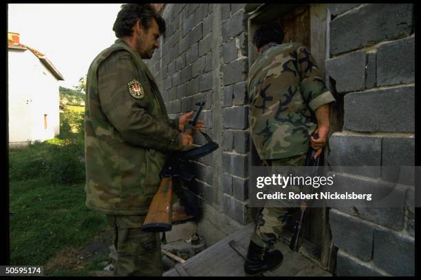 Bosnian Serb troops entering home on Serbian-held, Muslim-surrounded civil war front in ex-Yugoslav republic.