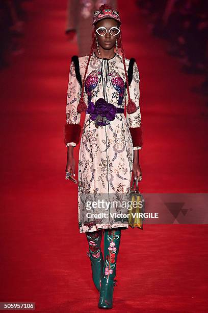 Model Nicole Atieno walks the runway at the Gucci show during Milan Men's Fashion Week Fall/Winter 2016/17 on January 18, 2016 in Milan, Italy.