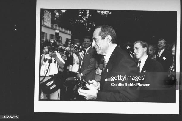Gov. Mario Cuomo walking past mass of photographers as he arrives at the Reebok party for Dem. Supporters during the wk. Of the Dem. Natl....
