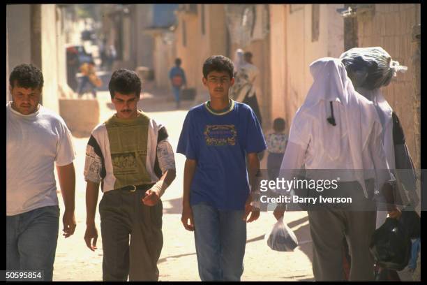Trio of youths, Palestinian residents of Baqaa refugee camp, biggest in world, home to 1948 & 1967 Arab/Israeli war refugees.
