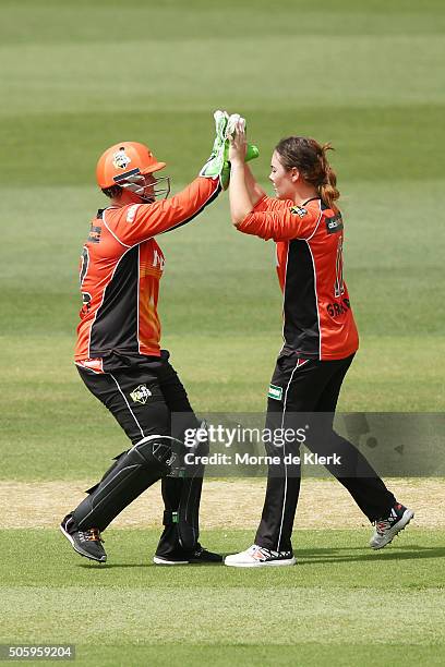 Heather Graham and Jenny Wallace of the Perth Scorchers celebrate after Graham bowled out Nicola Carey of the Sydney Thunder during the Women's Big...