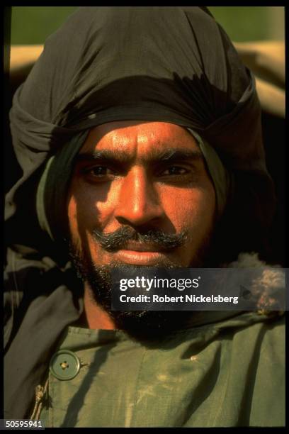 Sikh Indian army soldier w. Black cloth-over-turban & beard serving w. Mostly BSF paramil. Forces enforcing curfew imposed on separatist-minded...