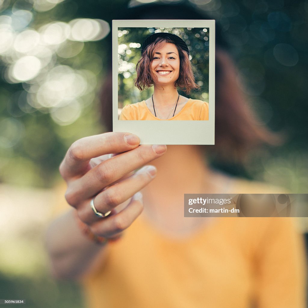 Girl holding instant selfie