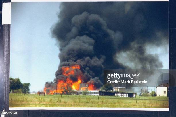 Smoking fire consuming David Koresh-led Branch Davidian cult compound; it remains unclear if the fire was started on the orders of Koresh or when...