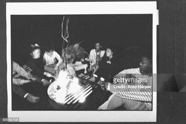 Hofstra Univ. Prof Douglas Brinkley playing guitar around a campfire for his girlfriend Tamra Cimalore , & students Dave Terreri , Stephanie Prager ,...