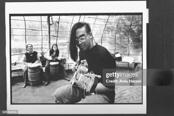 Hofstra Univ. Student Ronald Kasilag playing guitar, while fellow students Gale Greenstein & Janine Hayes accompany him on drums at the Green...