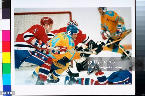 Red, white & blue-uniformed members of Russian Penguins ice hockey team playing against Kiev Eagles at CSKA Arena .;1993