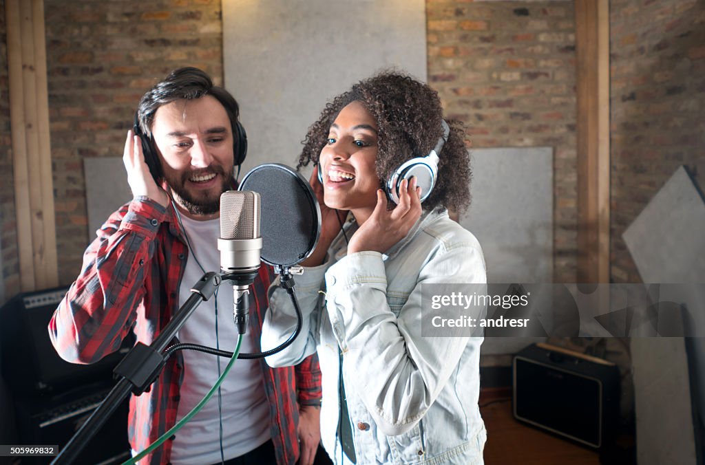 Singers singing at a recording studio