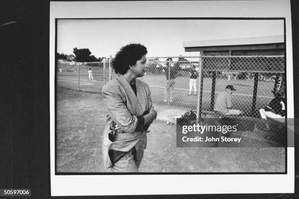 Griefing Alexandra Matteucci, the mother of 17-yr-old Joseph Matteucci, standing outside fence at baseball field where her son was murdered w. A...