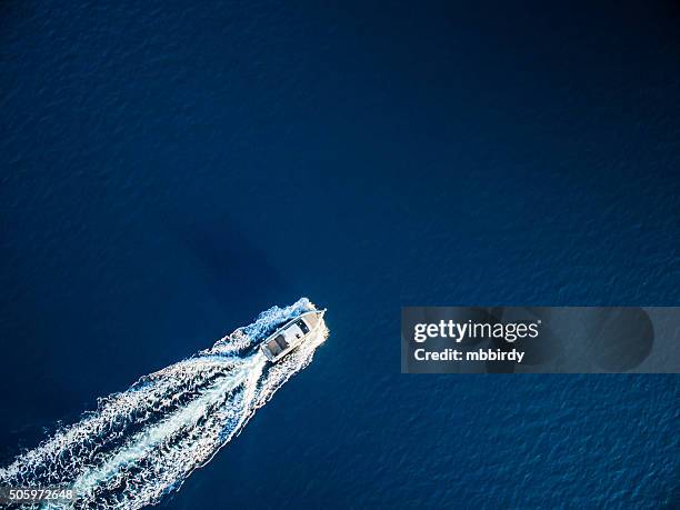 speedboat racing along the open sea - motorboat stockfoto's en -beelden