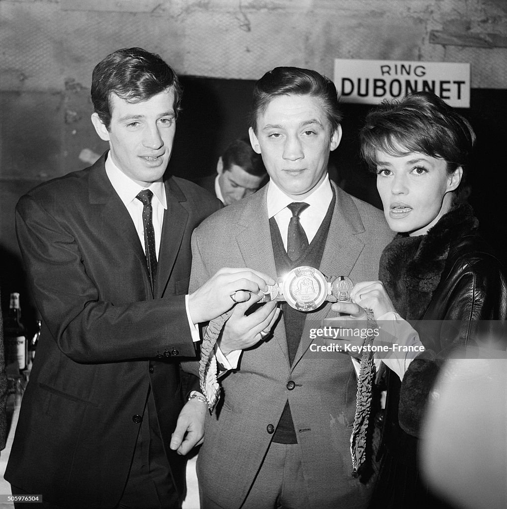 Boxer Maurice Auzel Receives His Champion Belt From Actors Jean-Paul Belmondo And Jeanne Moreau At The Studios Of Billancourt...