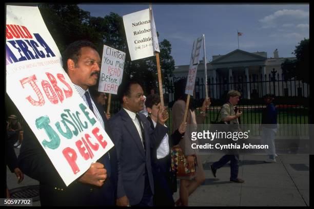 National Rainbow Coalition's Jesse Jackson & DC Rep Fauntroy outside WH with Rebuild America: Jobs Justice Peace protest message for President...