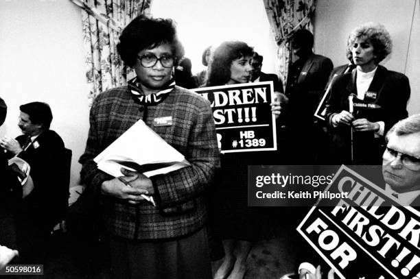 Surgeon Gen. Nominee Dr. Joycelyn Elders , the Dir. Of the AR Dept. Of Public Health, standing amid small group of people, some of whom are carrying...