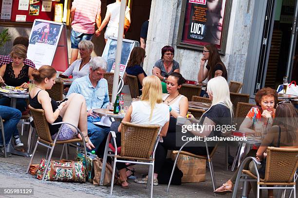 adult man and four girls sitting at table - senior essen stock pictures, royalty-free photos & images