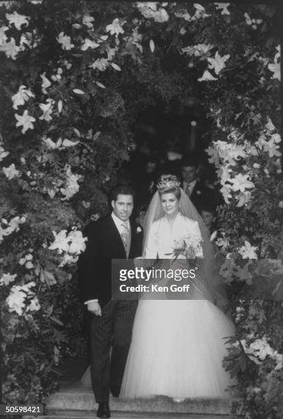 England's Viscount Linley and bride Serena Stanhope walking through a flowered arch after taking their wedding vows at St. Margaret's Church,...