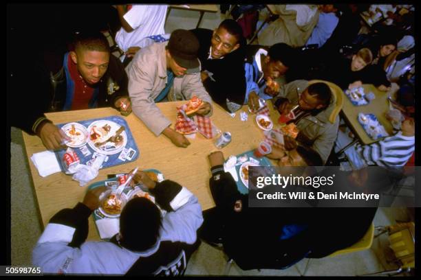 High School students eating Pizza Hut pizza, re PepsiCo.'s restaurant chain's concessions in airports, hospitals & schools.