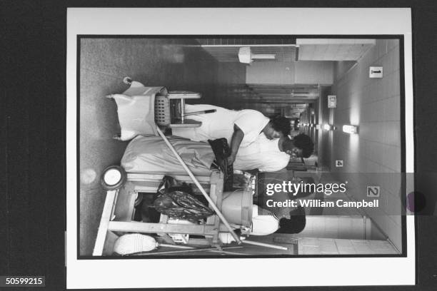Bessie Pender , a former school janitor who put herself through college to become a teacher, chatting w. Custodian Helen Gray, teachers' asst....