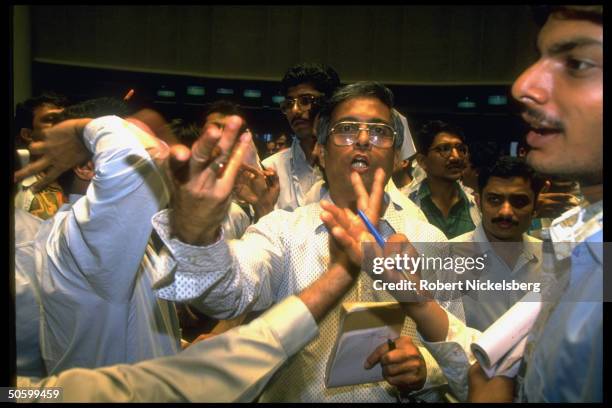 Traders making hand signals on frantic floor of Bombay Stock Exchange, India's most active exchange w. Overseas investment pouring into market.