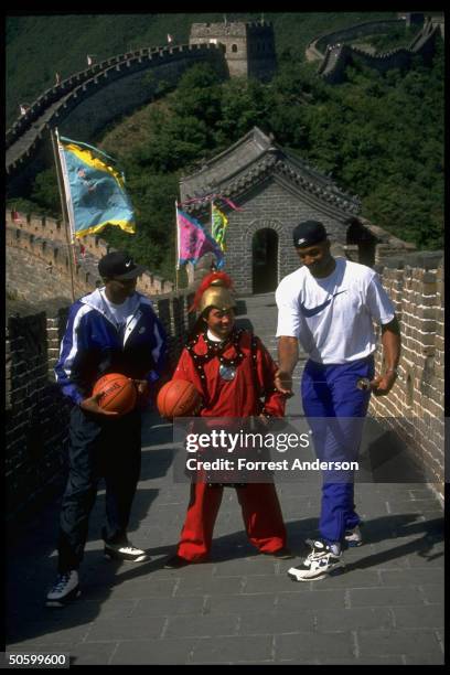 Amer. Basketball pros Alonzo Mourning & Anfernee Penny Hardaway w. Costumed guard at Great Wall, taking time out fr. Playing against Chinese natl....