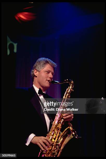 Pres. Bill Clinton playing saxophone at DC Armory Ball during inaugural wk. Festivities.