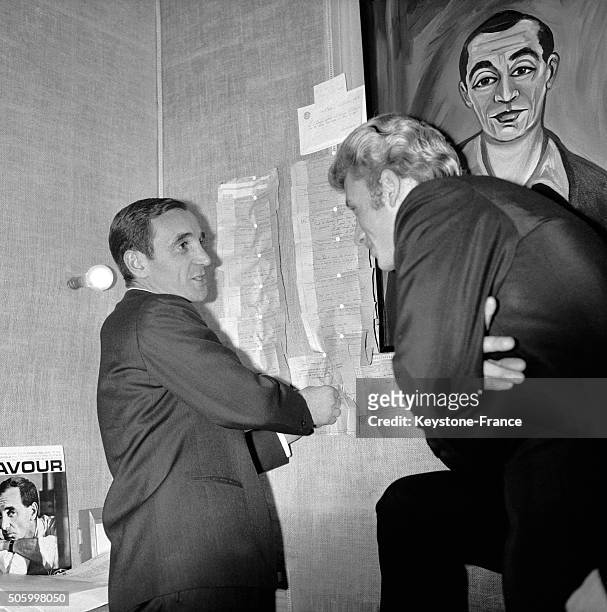 Charles Aznavour In His Dressing Room Of Paris Olympia Music Hall Receives The Congratulations Of Singer Johnny Hallyday For His Song Recital, in...