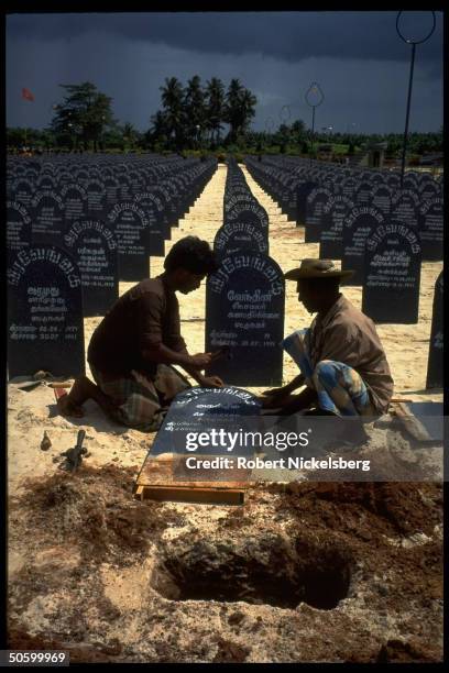 Workers preparing fresh graves at Tamil separatist Liberation Tigers of Tamil Eelam cemetery .