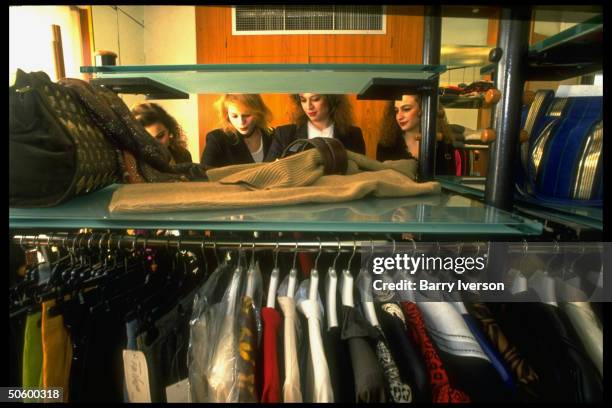 Lebanese college girls browsing through racks of clothing, shopping at new, swanky upscale Verdun Plaza shopping mall.